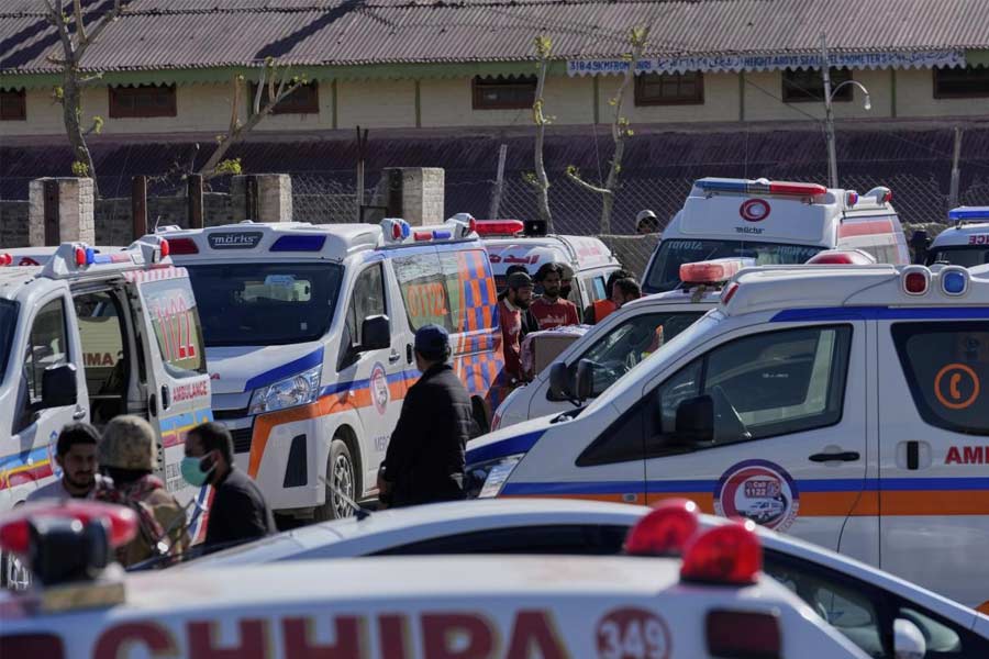 Ambulances wait for the arrival of the bodies of victims from a passenger train attacked by insurgents at a railway station in Much, Pakistan's southwestern Balochistan province.