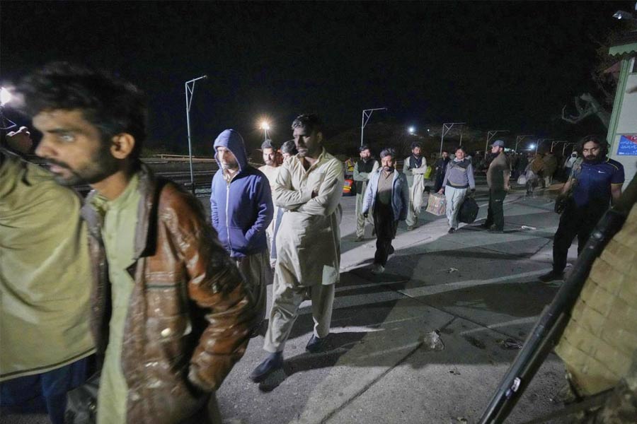 Passengers rescued by security forces from a passenger train attacked by insurgents arrive at a railway station in Much, Pakistan's southwestern Balochistan province.