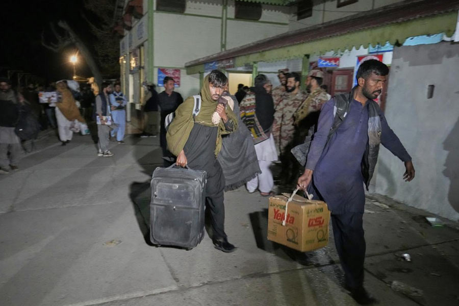 Passengers rescued by security forces from a passenger train attacked by insurgents arrive at a railway station in Much, Pakistan's southwestern Balochistan province.
