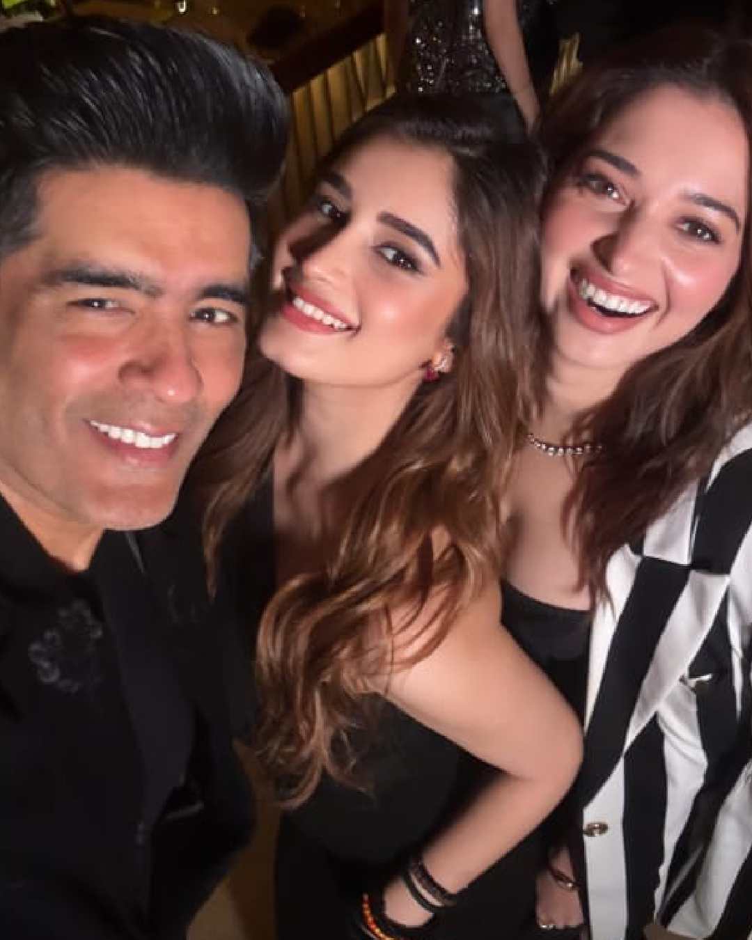 Tamannaah stunned in a striped oversized shirt worn atop a black dress. A silver necklace and tinted cheeks enhanced her glamour quotient. Rasha and Tamannaah attended Pragya Kapoor's Holi bash.