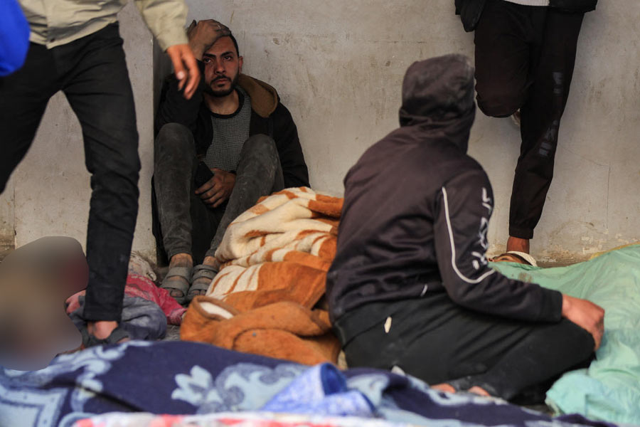 Mourners gather near the bodies of Palestinians killed in Israeli strikes, at a hospital in Gaza City.