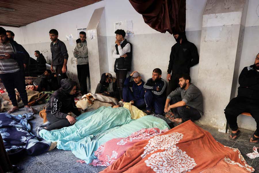 Mourners gather near the bodies of Palestinians killed in Israeli strikes, at a hospital in Gaza City.
