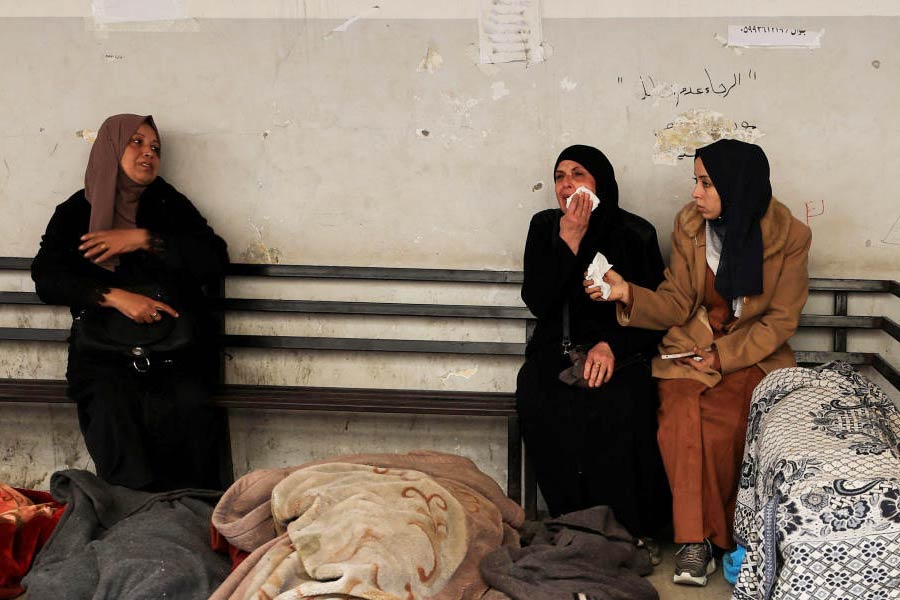 Mourners gather near the bodies of Palestinians killed in Israeli strikes, at a hospital in Gaza City.