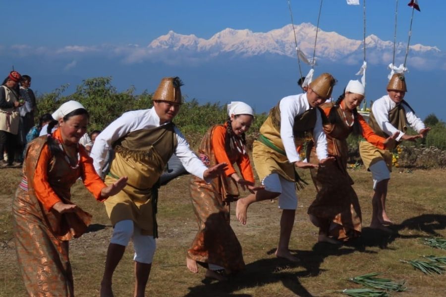 The band performing in the hills with the Kanchenjunga in the background
