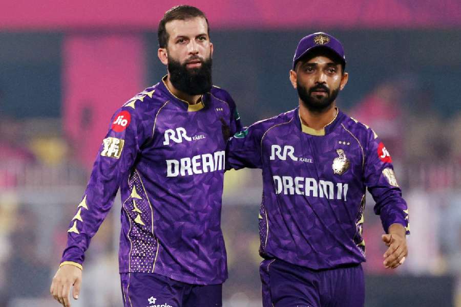 Kolkata Knight Riders' Moeen Ali celebrates with Ajinkya Rahane after taking the wicket of Rajasthan Royals' Yashasvi Jaiswal, caught out by Harshit Rana.
