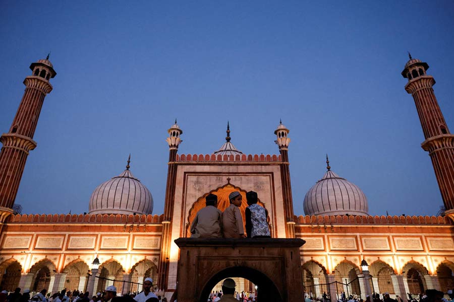 Muslim children sit in the mosque before prayers at Jama Masjid on the occasion of Eid al-Fitr, in the old quarters of Delhi, India.