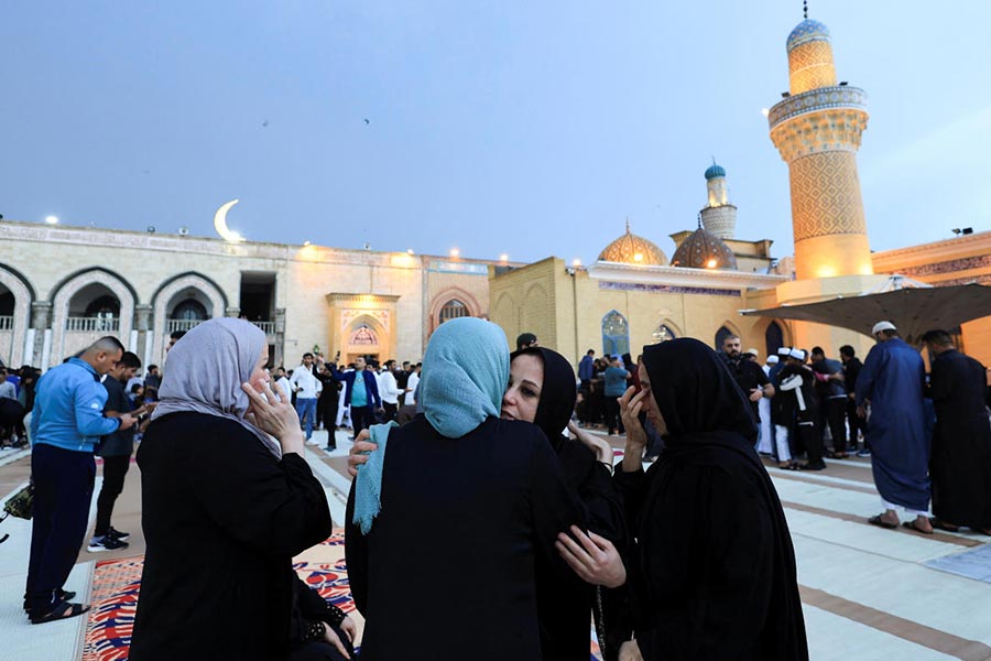 Sunni Muslim worshippers exchange greetings after Eid al-Fitr prayers marking the end of the holy fasting month of Ramadan at the shrine of cleric Sheikh Abdul Qadir al-Gailani in Baghdad, Iraq.