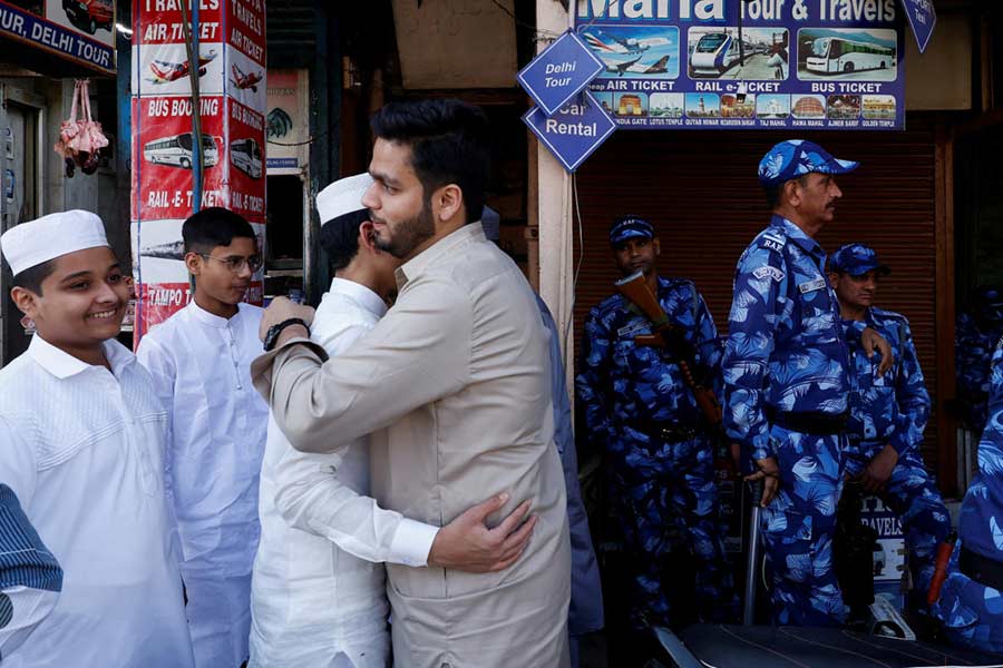 Muslim boys greet each other on Eid al-Fitr in the old quarters of Delhi.