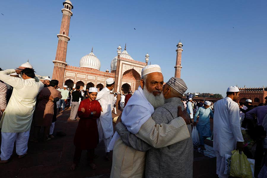 Muslim men greet each other on the occasion of Eid al-Fitr at Jama Masjid, in the old quarters of Delhi.