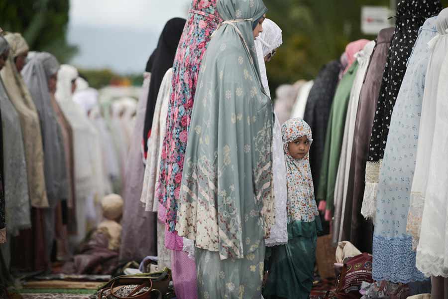 A girl looks on as she attends mass prayers at Baiturrahman mosque during Eid al-Fitr, marking the end of the holy fasting month of Ramadan in Banda Aceh, Indonesia.