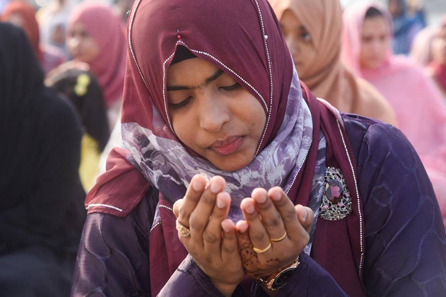 A woman attends Eid al-Fitr prayers at Galle face in Colombo, Sri Lanka.