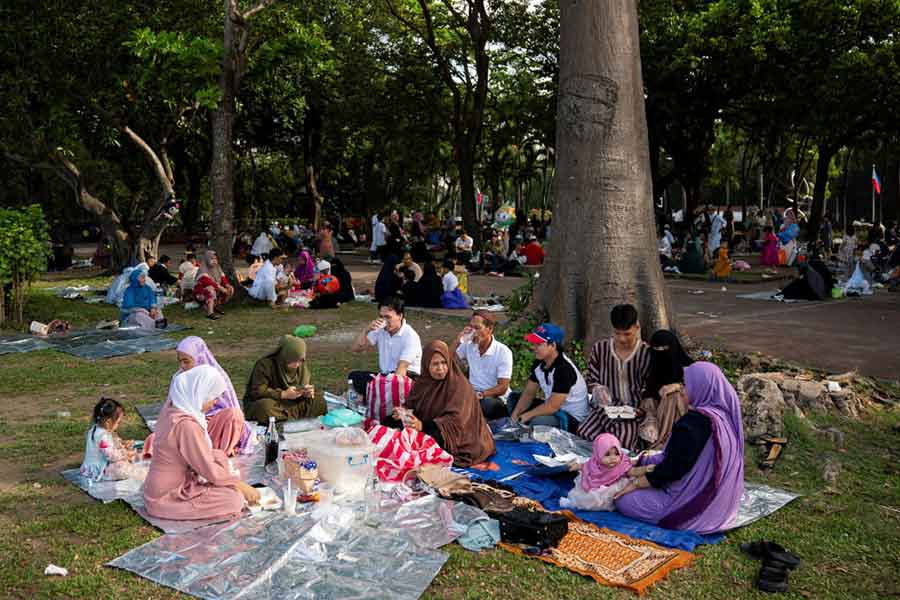 Filipino Muslims share a meal after Eid al-Fitr prayers to mark the end of the holy month of Ramadan, in Manila, Philippines.