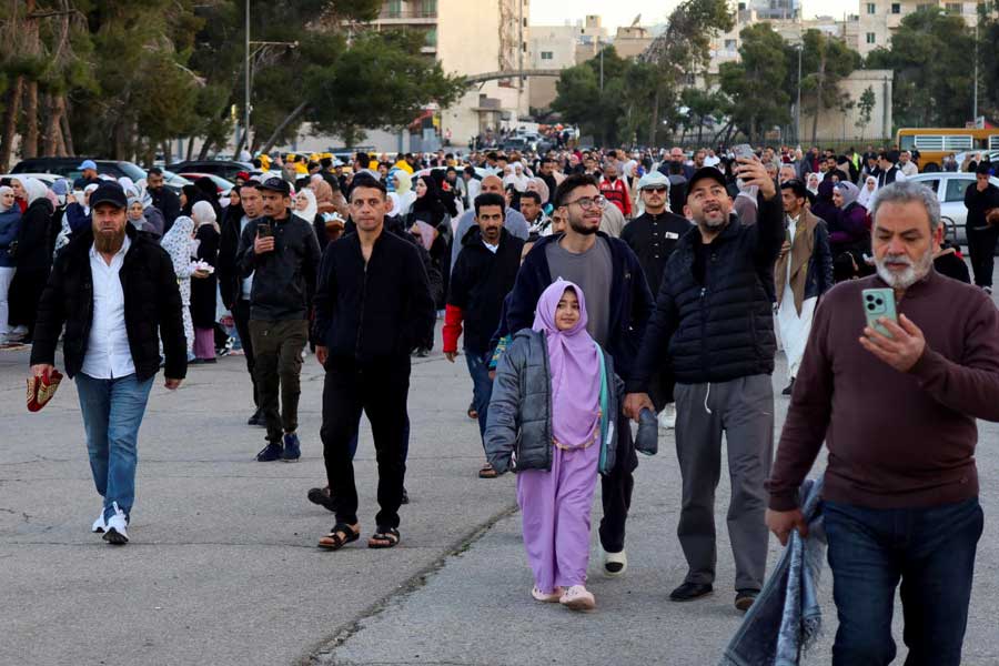 Muslims walk to attend the Eid al-Fitr prayer to mark the end of the holy fasting month of Ramadan in Amman, Jordan.