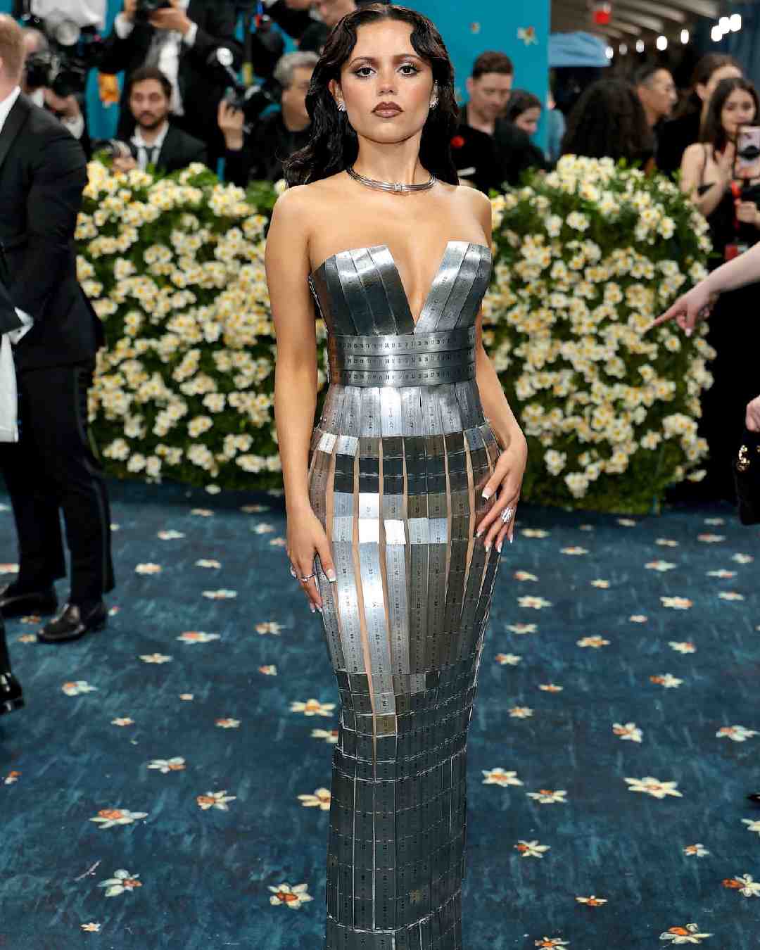 Jenna Ortega walked the red carpet in a Balmain metallic sheath dress.