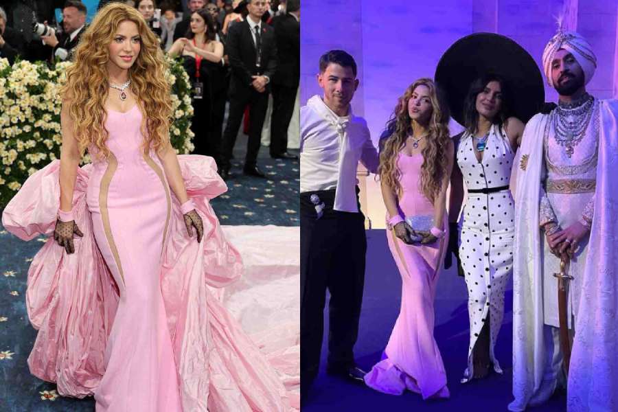 Shakira stood out in a powder-pink gown with a massive cape that flowed into a train behind her. 