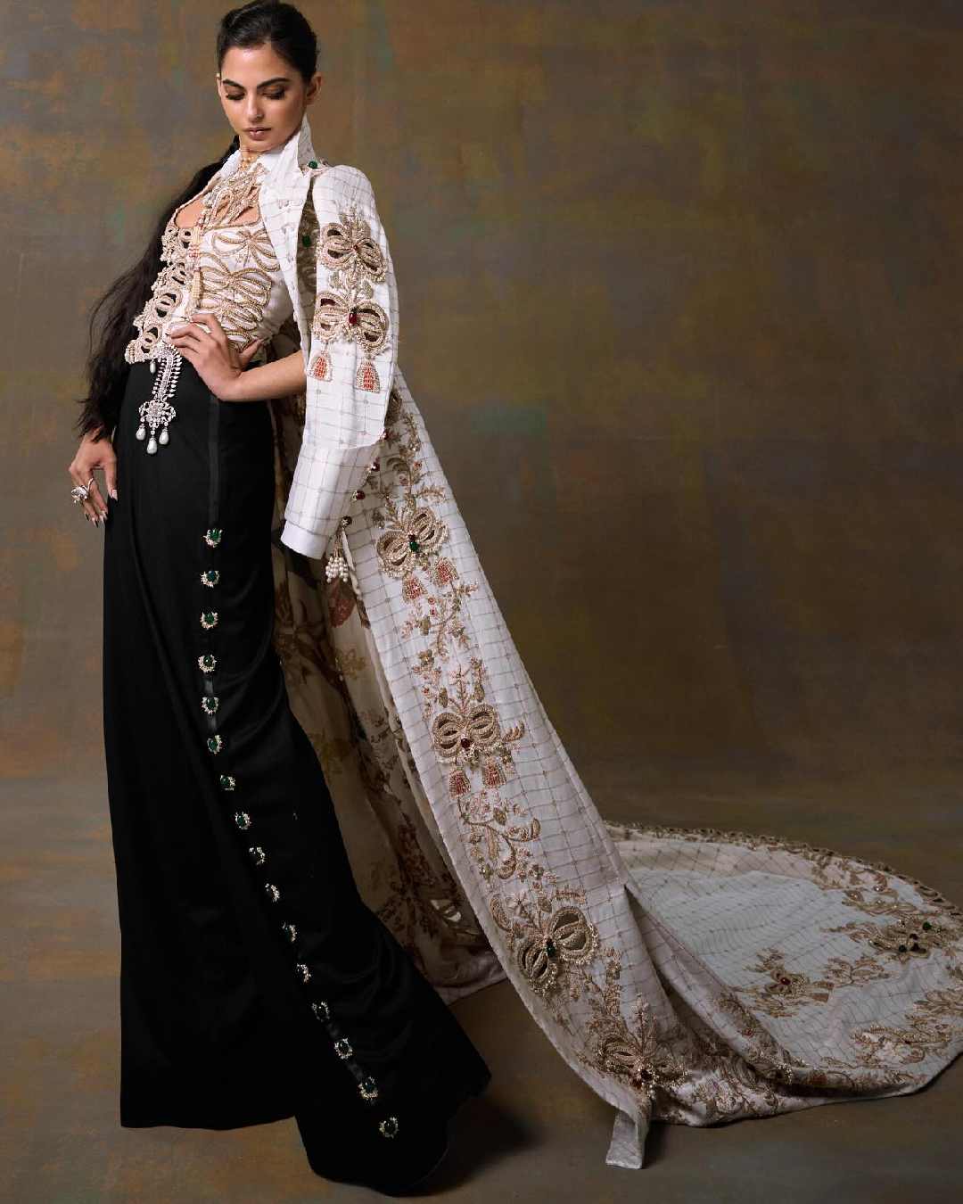 Isha Ambani stunned in a striking Anamika Khanna ensemble comprising a heavily embroidered blazer, a corset-fit bodice and black trousers.