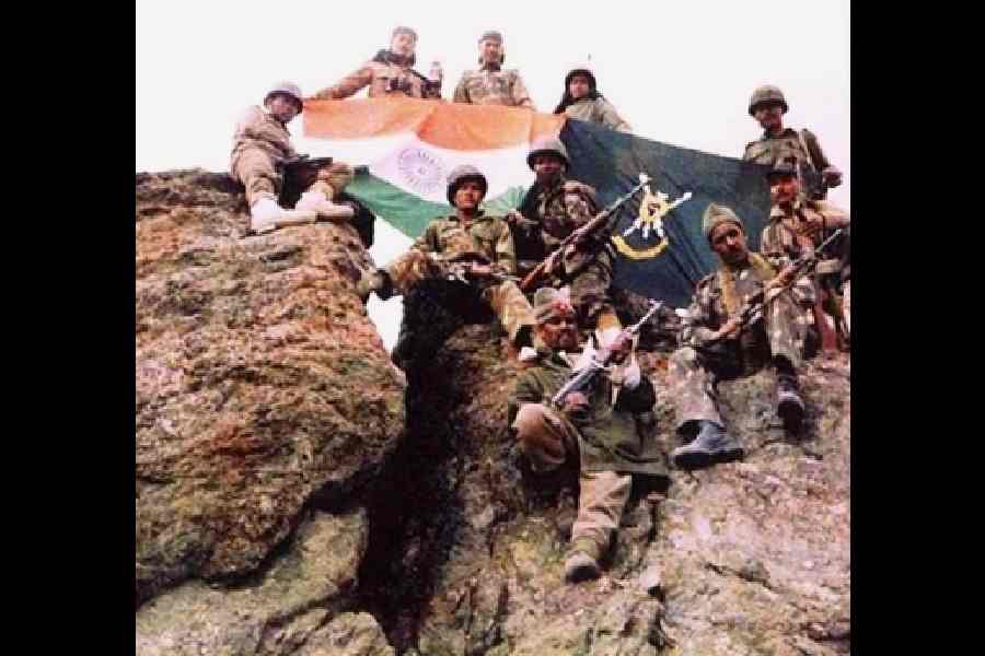 Indian soldiers stand guard after capturing a hill from Pakistani forces during the Kargil War.