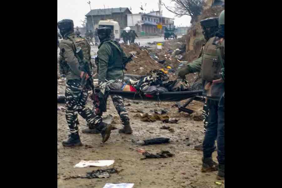 Jawans carry a victim after militants attacked their CRPF convoy in Pulwama on Februrary 14.