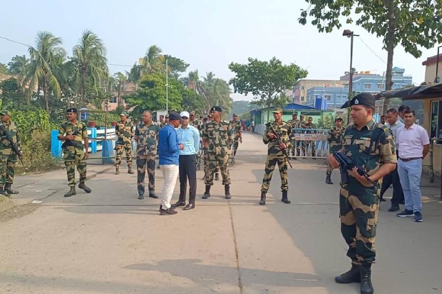 BSF personnel patrol the road approaching the Ghojadanga land port in North 24-Parganas on Friday.