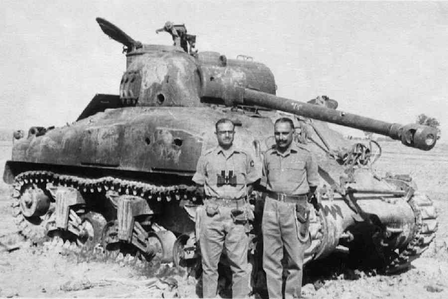 Indian soldiers with a destroyed Pakistani M4A1 Sherman tank.