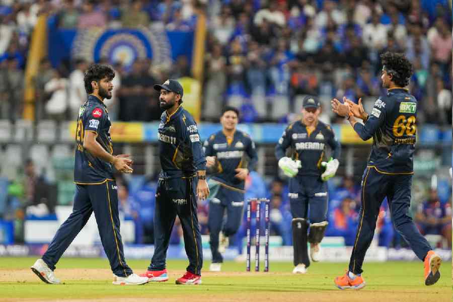 Gujarat Titans' Arshad Khan with teammates celebrates the wicket of Mumbai Indians' Rohit Sharma during the IPL 2025