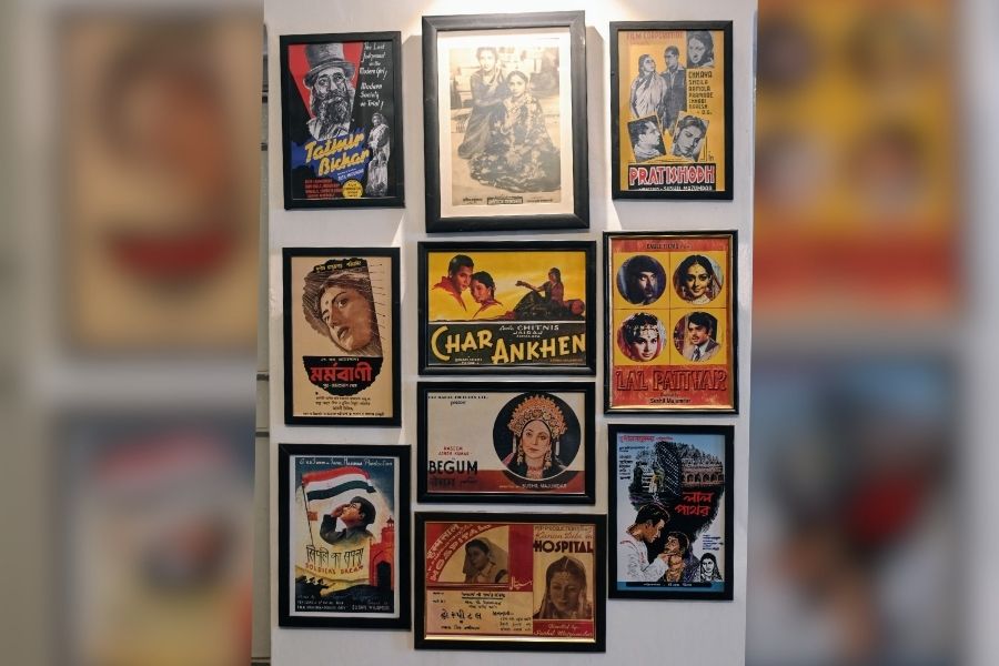 A wall at Majumdar’s Kolkata residence featuring digitally restored posters of his films Credit: 