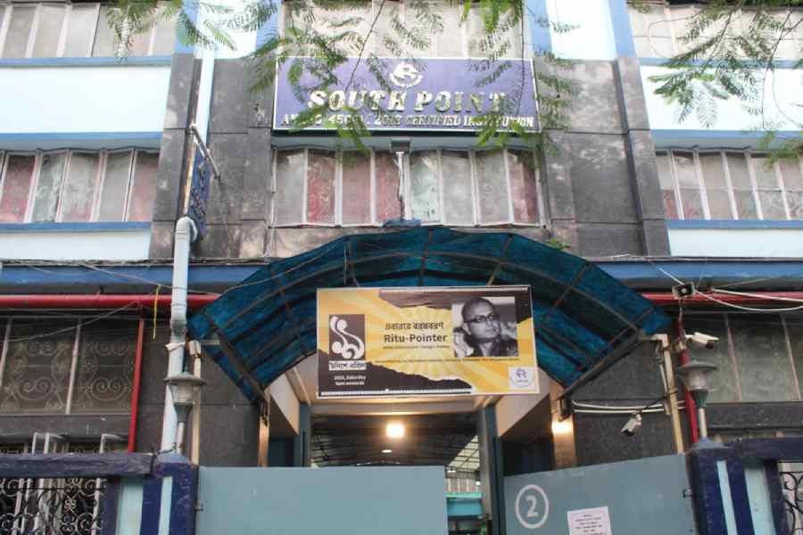 A banner announcing the programme hangs over the entrance to South Point School