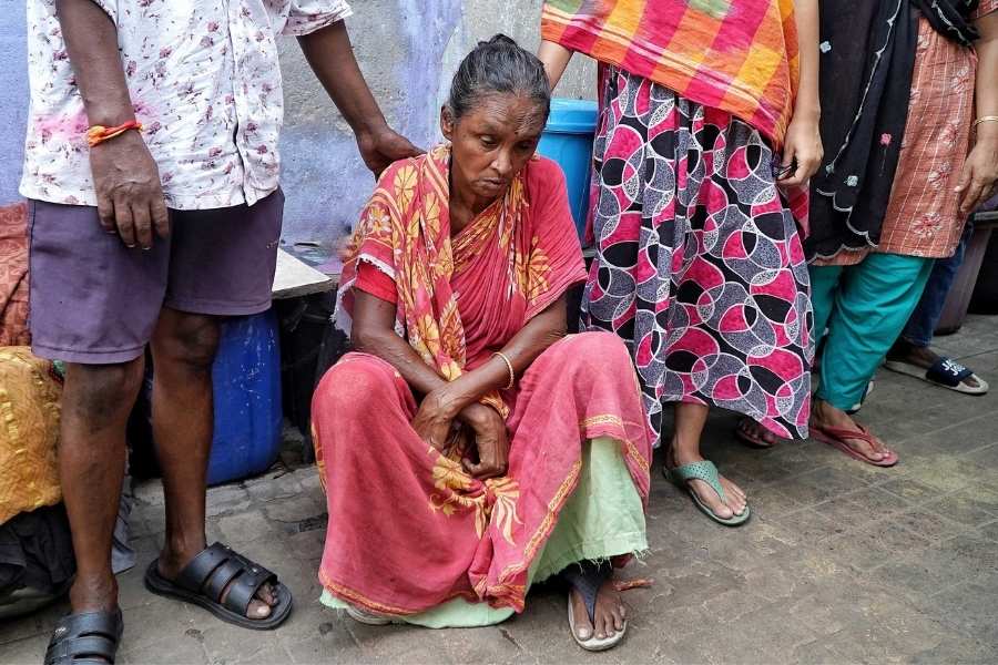A member of the displaced family breaks down in tears