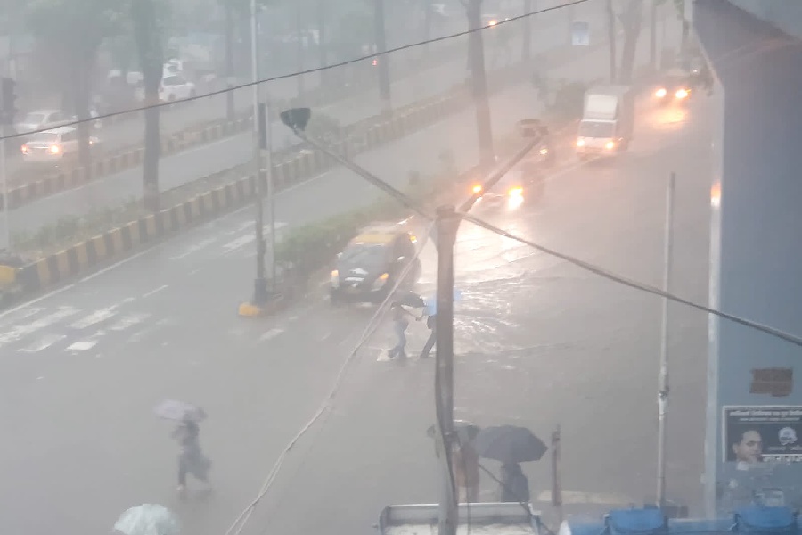 Visibility dips as vehicles, commuters navigate waterlogged street in Wadala West near railway station