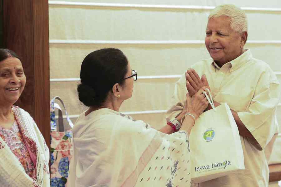 West Bengal Chief Minister Mamata Banerjee greets RJD President Lalu Prasad Yadav on the birth of his grandson, in Kolkata.