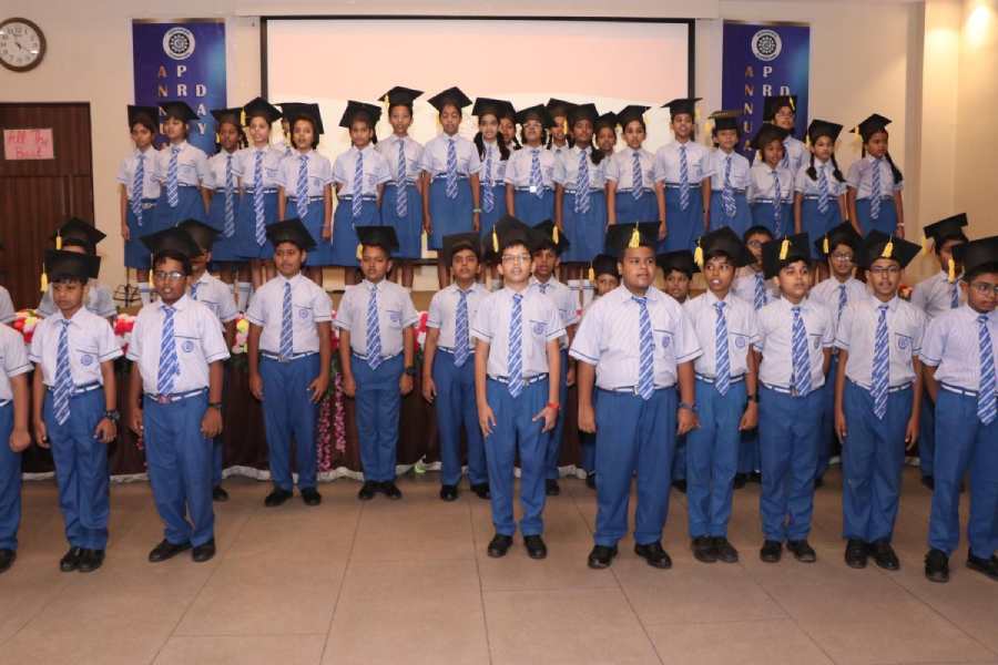 Students of Class VI celebrate stepping into middle school with graduation hats