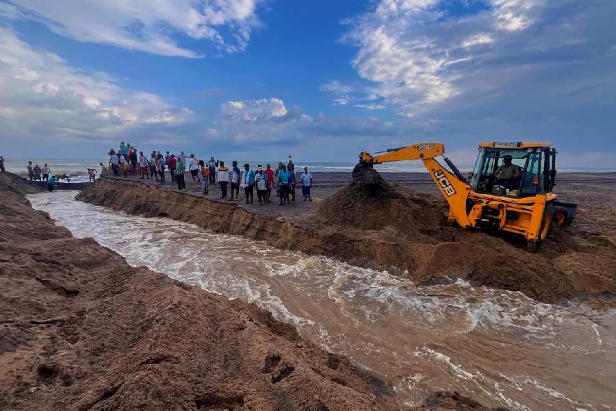 Villagers dig a new river mouth in Ganjam on Thursday