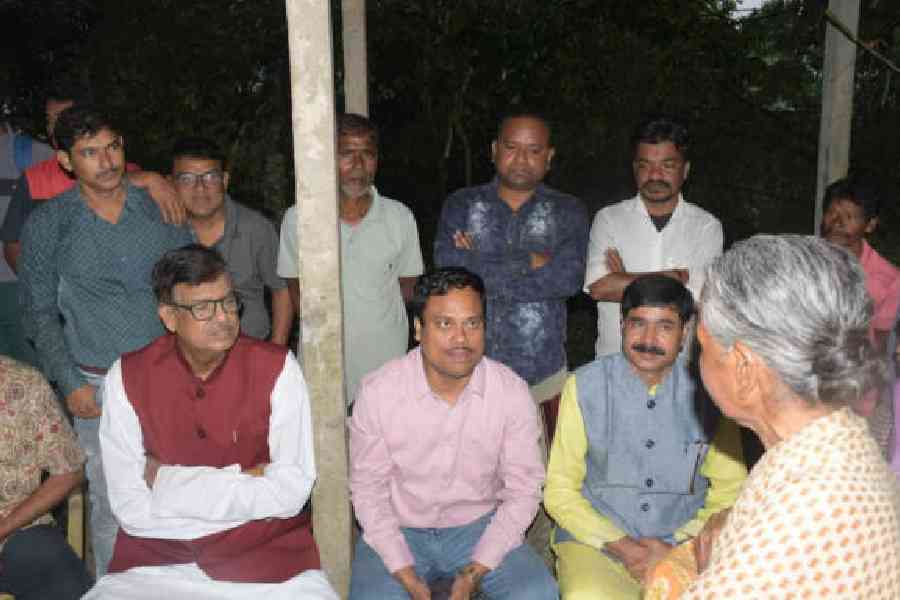 Trinamool leaders Rabindranath Ghosh (in maroon jacket) and Parthapratim Roy (in pink shirt), along with some other party leaders, speak with voters in booth 303 of Cooch Behar north Assembly seat at Khapaidanga area of Cooch Behar on Friday.  Picture by Main Uddin Chisti