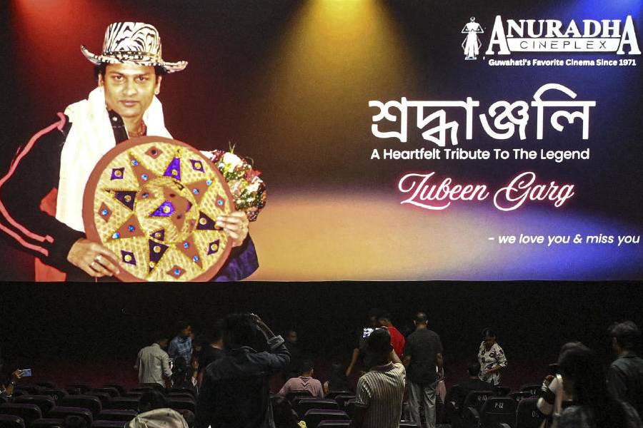 Fans of late singer and actor Zubeen Garg watch his final film 'Roi Roi Binale', inside a movie theatre, in Guwahati, Assam, Friday, Oct. 31, 2025.