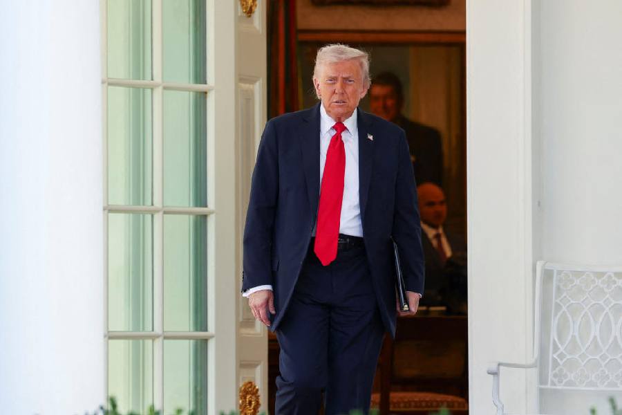 USPresident Donald Trump exits the Oval Office to speak at a Rose Garden Club lunch at the White House