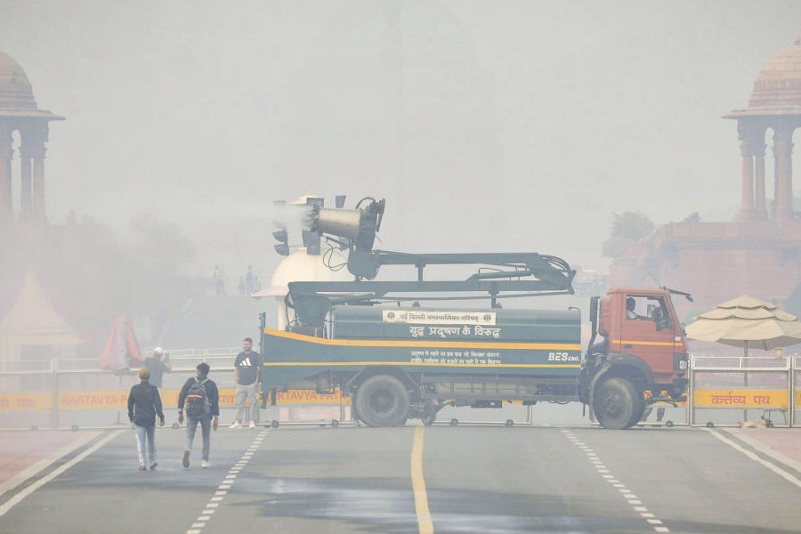 An anti-smog gun is being used to spray water droplets to curb air pollution, near Rashtrapati Bhavan, in New Delhi, Saturday, Nov. 1, 2025.