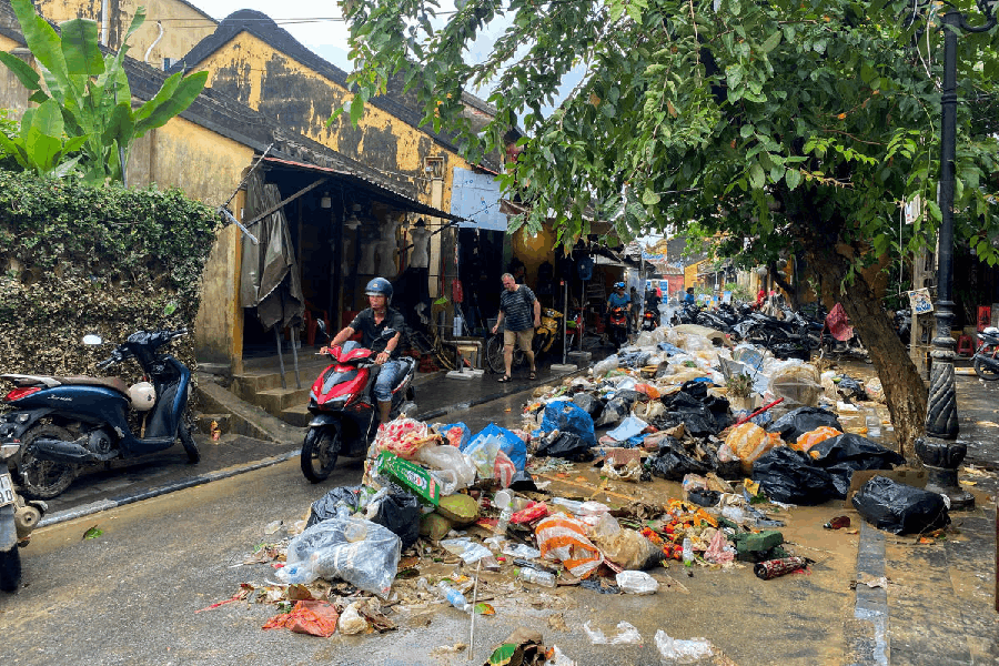 A person rides a vehicle past debris following floods in central Vietnam that have killed several people, in Hoi An, Vietnam, November 1, 2025.