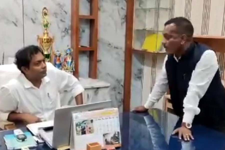 A grab from a video clip showing Manoj Tigga, the BJP MP of Alipurduar, at the chamber of the Madarihat block development officer, Amit Kumar Chourasia, on Thursday