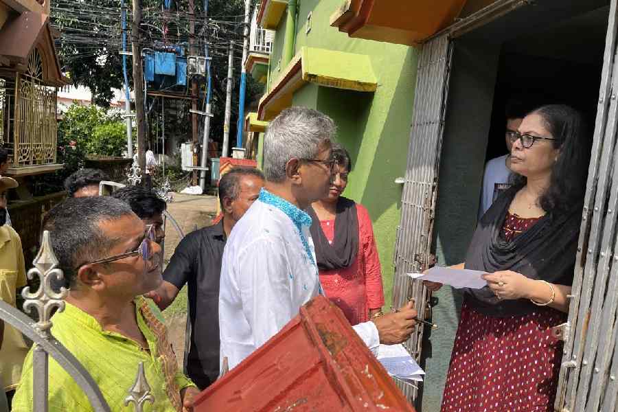TMC leaders headed by New Barrackpore Municipality chaiman Prabir Saha (in white kurta) distributing photocopy of 2002 electoral roll at the doorstep of the voters