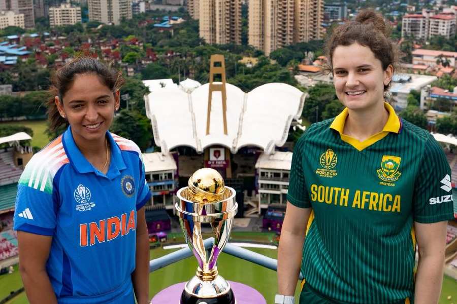 Captains Harmanpreet Kaur and Laura Wolvaardt withthe Women’s World Cup trophy on the eve of the final in Navi Mumbai.