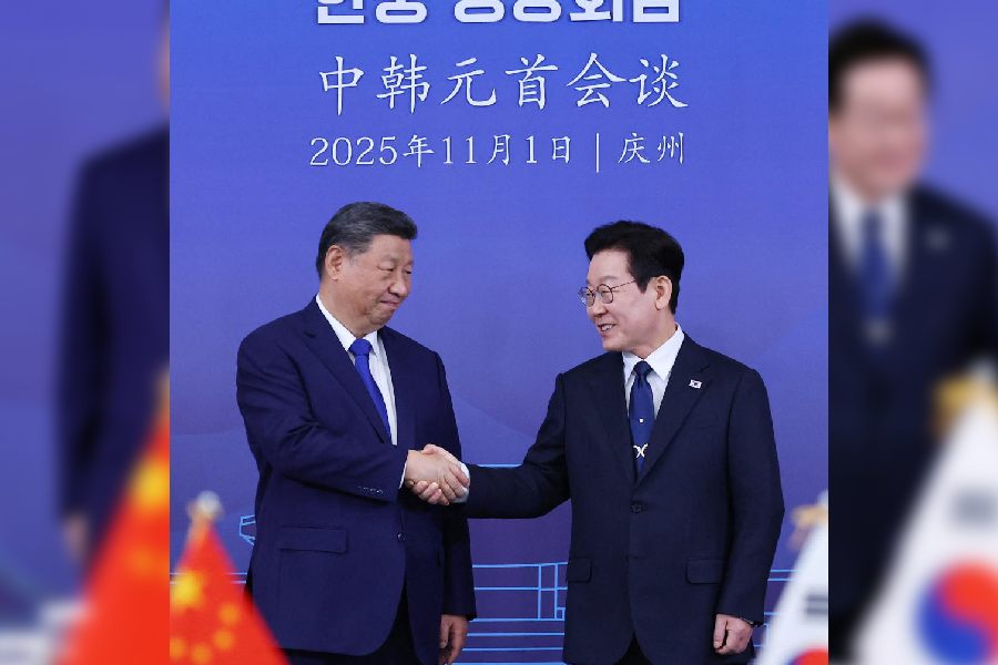 China's President Xi Jinping shakes hands with South Korea's President Lee Jae Myung during their meeting in Gyeongju