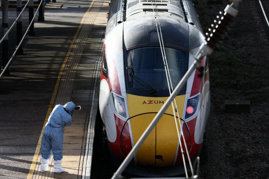 A forensic officer takes pictures of the London North Eastern Railway (LNER) train where a series of stabbings took place, at a platform at Huntingdon Station, near Cambridge, Britain, November 2, 2025.