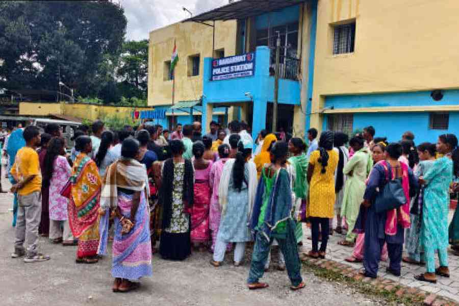 The workers of Debpara tea estate gather in front of the Banarhat police station in Jalpaiguri district on Sunday. Picture by Biplab Basak