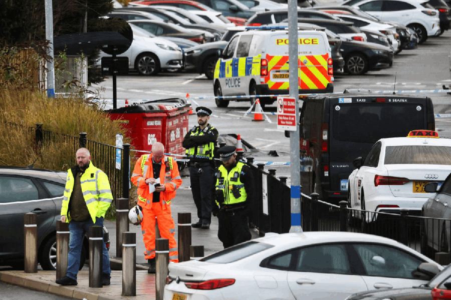 Police officers and emergency personnel work at the scene following a stabbing incident at a train station in Huntingdon, Britain, November 2, 2025.