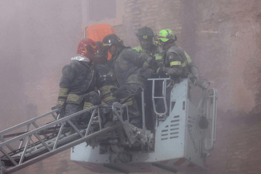 Dust rises after parts of the Torre dei Conti tower collapsed, as emergency service members work at the scene near Via dei Fori Imperiali, close to the Colosseum in Rome, Italy, November 3, 2025.