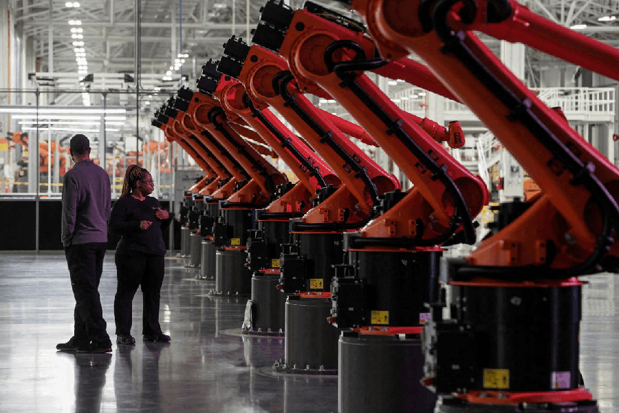 File photo: People are seen next to robotic arms for a second battery tray assembly line at the opening of a Mercedes-Benz electric vehicle Battery Factory, in Woodstock, Alabama, U.S.