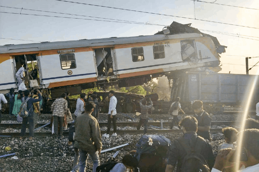 People gather after a passenger train collided with a goods train near Bilaspur railway station, Chhattisgarh, Tuesday, Nov. 4, 2025.
