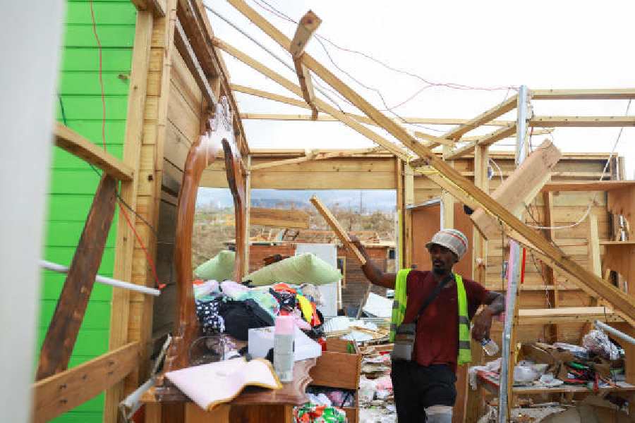 A man shows the damage caused to his house by Hurricane Melissa in Belmont, Jamaica, on Sunday.