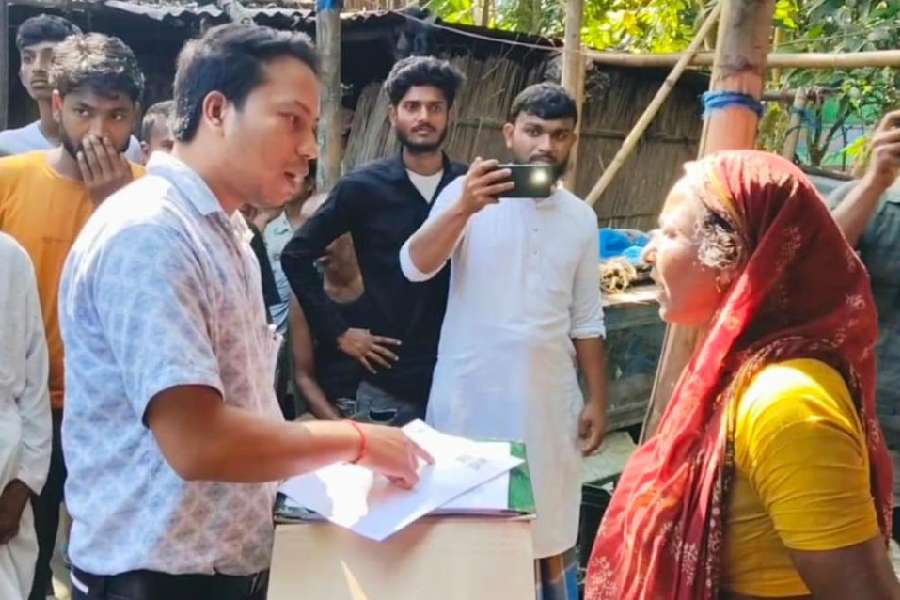 Bipul Modak, a BLO, tries to persuade a resident at Poaturkuthi, an erstwhile Bangladeshi enclave in Cooch Behar, to fill up an enumeration form on Tuesday. Residents refused to receive the forms from him. 