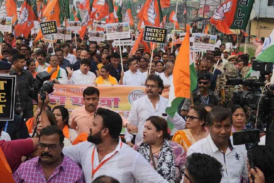 Suvendu Adhikari holds up placards announcing the themes of the BJP rally in Sodepur on Tuesday.